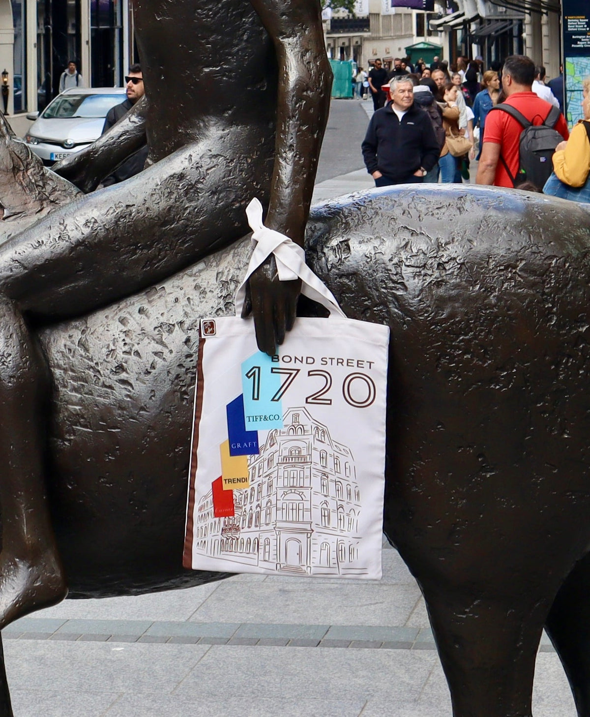 Bond St 1720 tote hung on a bronze horse statue on Bond Street