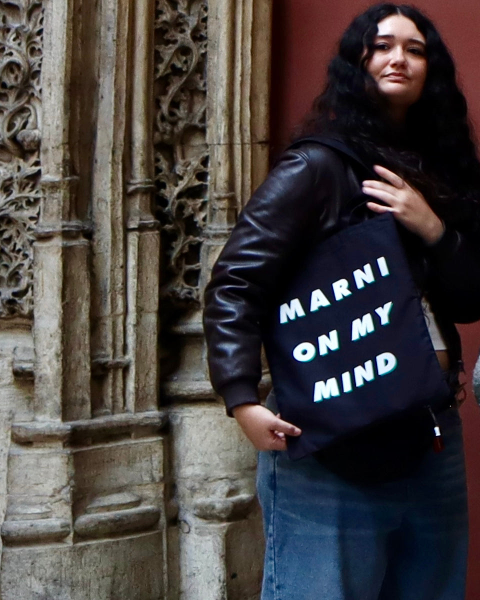 MARNI tote carried on the shoulder by a carved stone doorway